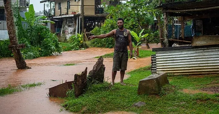 Tomasi Luvuiwai points out the flooded waters outside their residence caused by the heavy rain and blocked drain in Davuilevu on 5, February 2023. Photo: Leon Lord
