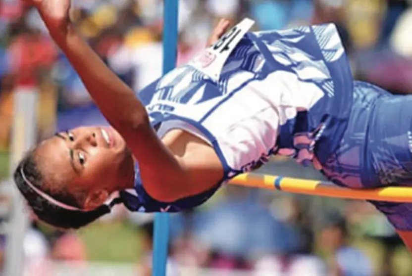 Shawntell Lockington jumps over the bar during the senior girls high jump event.
