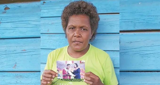Nanise Mawamawa, mother of the late Maritino Tikoisavusavu, holds up a photo of her son.