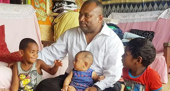 Minister for Health and Medical Services Dr Ifereimi Waqainabete in Wainadoi with Angelo Morris, 6, (left) and Iowane Ravuama (on minister’s lap).
