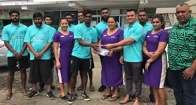 Members of the Nadi Futsal team receives the sponsorship cheque from staff of Reliance Pharmacy at Nadi yesterday. Photo: Waisea Nasokia
