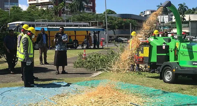 Minister for Agriculture, Waterways and Environment Mahendra Reddy (far left) observes the work carried out by the shredder machine outside the Suva Civic Centre on April 22, 2022. Photo: Inoke Rabonu