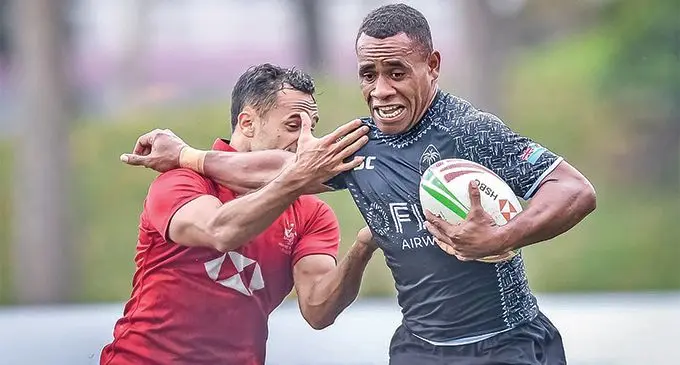 Fiji Airways Fijian 7s back Livai Ikanikoda fends Hong Kong’s Ben Rimene during a practice match at the Hong Kong Institute of Sports on March 30, 2019. 