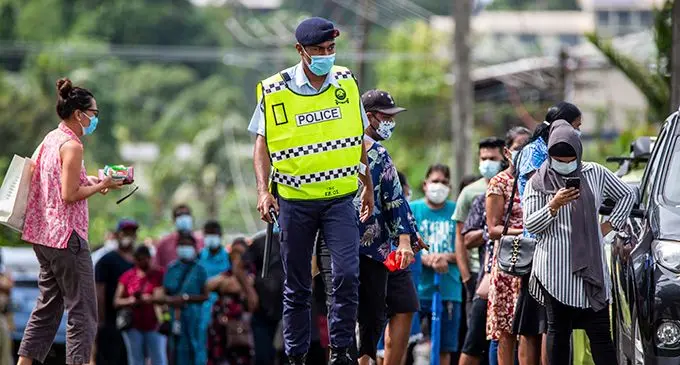Police officers enforcing social distancing as members of the public  line in numbers for thier vaccinations at the QVOB Club, Toorak in Suva on May 4th 2021. Photo: Leon Lord