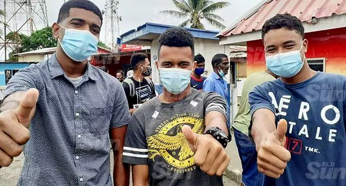 Happy Government unemployment assistance recipients (from left) Manu Brown, Jale Colata and Koresi Colata, after redeeming their $360 in Navua. Photo: Ronald Kumar