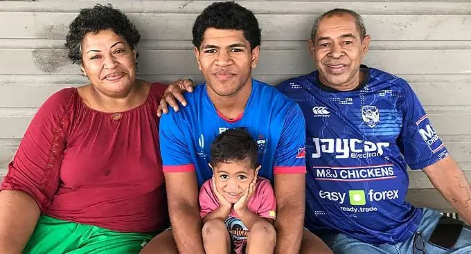 Former Queen Victoria School headboy Tomasi Seru Jnr is flanked by his parents Mere, Tomasi Seru Snr (right) and namesake (front) at their Davuilevu Housing home on January 5, 2023. Photo: Josefa Babitu