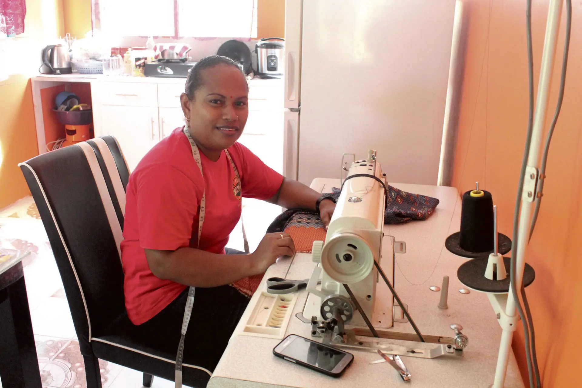 Unaisi Solaila with the sewing machine she bought with the money she received from the grant. Photo: Wati Talebula