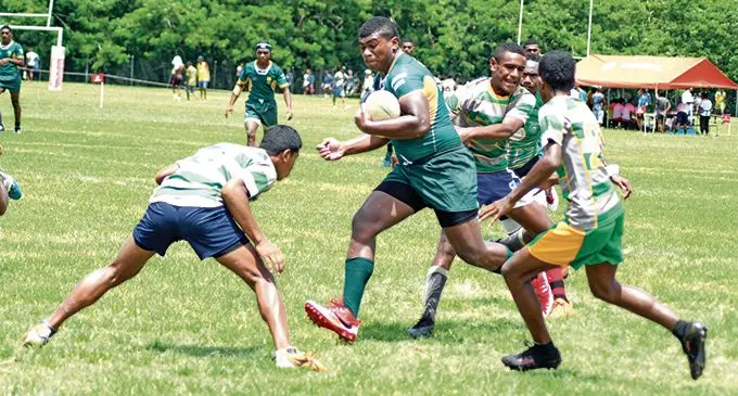 Penione Nawai (with ball) of RSMS looks for support against AOG during  Secondary School rugby leaque under 17 at Bedesi Park on February 16, 2019. Photo: Ronald Kumar.