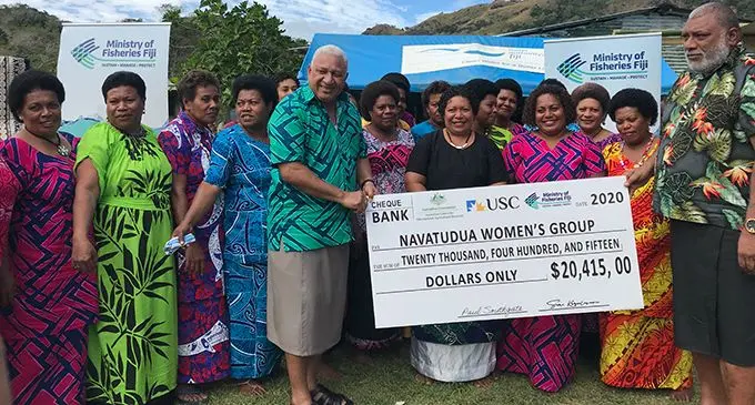Prime Minister Voreqe Bainimaram presents the cheque to members of the Navatudua Women’s Group.  Photo: Laisa Lui
