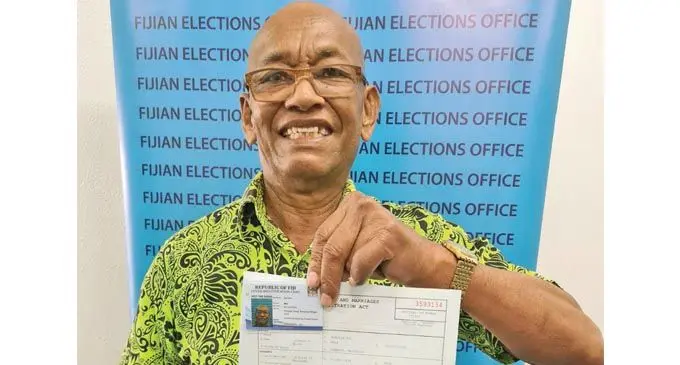 Asesela Niu with his New Birth Certificate and amended VoterCard