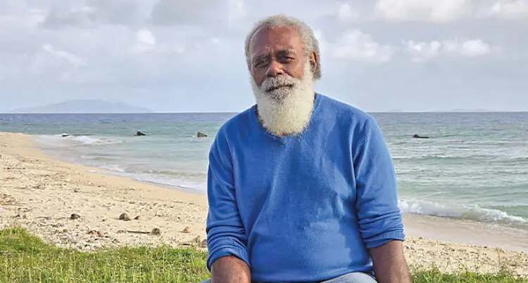 A photograph of Etuate Umu standing in front of Munia Island..