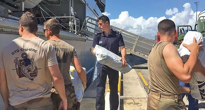Relief workers and soldiers load aid to Vanuatu after the devastation of cyclones Judy and Kelvin. Photo: RNZ Pacific