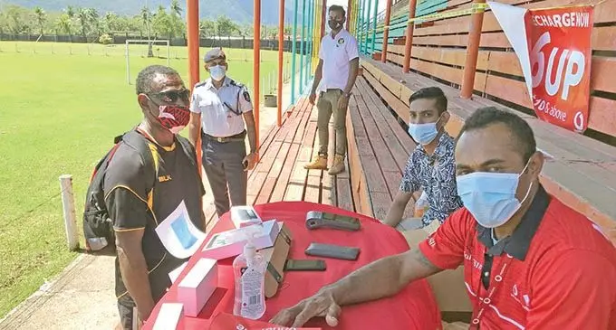 Vodafone Fiji Limited staff Jerry Vakalutu and Munish Prasad serving Panapasa Motosiri (left) at Subrail Park in Labasa on September 8, 2021. Photo: Shratika Naidu