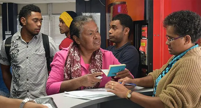 An Immigration office staff helps a customer with her Passport in Suva on September 13, 2019. Photo: Ronald Kumar
