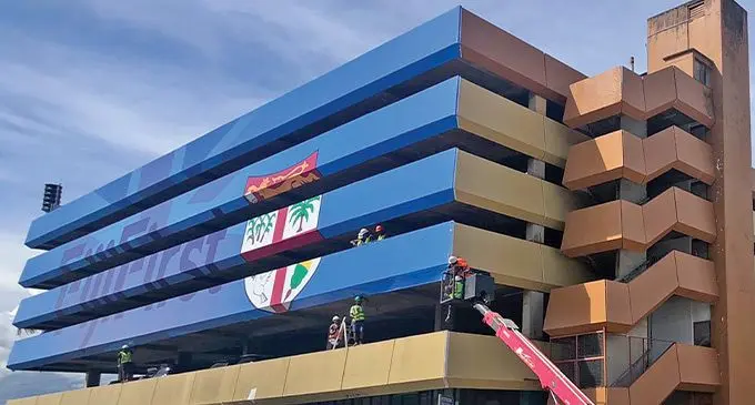 Workers work on putting up the FijiFirst campaign material at the Curio Handicraft Centre in Suva on December 1, 2022. Photo: Inoke Rabonu