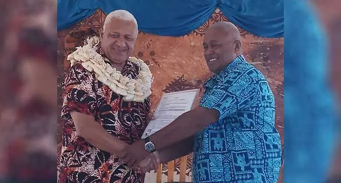 Land development advisor, Alipate Tavai receiving the land lease documents from Prime Minister, Voreqe Bainimarama at Vuda, Lautoka on October 11, 2022. Photo: Nicolette Chambers