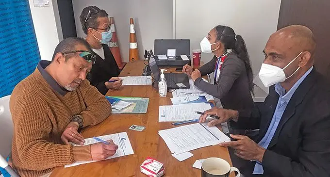 Fijian Elections Office staff Shital Prasad (third from left) and Siriako Raogo (right) attend to couple Aubrey Lee Wah (left) and wife Estella Lee Wah at the Hamilton registration centre, New Zealand on May 24, 2022. Photo: Nemani Delaibatiki