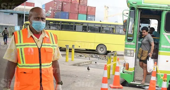 Suva City Council enforcement officer Jope Kete (left) monitors people’s movement at Suva bus stand as cone been placed at the bus stand for people to practice social distancing on March 31, 2020. Photo: Ronald Kumar.