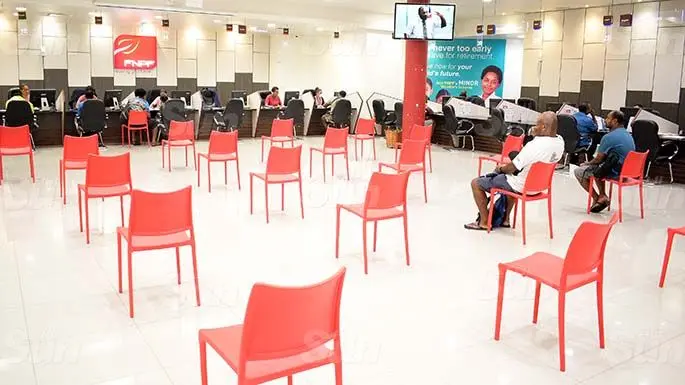 Fiji National Provident Fund Plaza staff, in Suva assists people with their quarries while practicing social distancing at the time on March 31, 2020. Photo: Ronald Kumar.