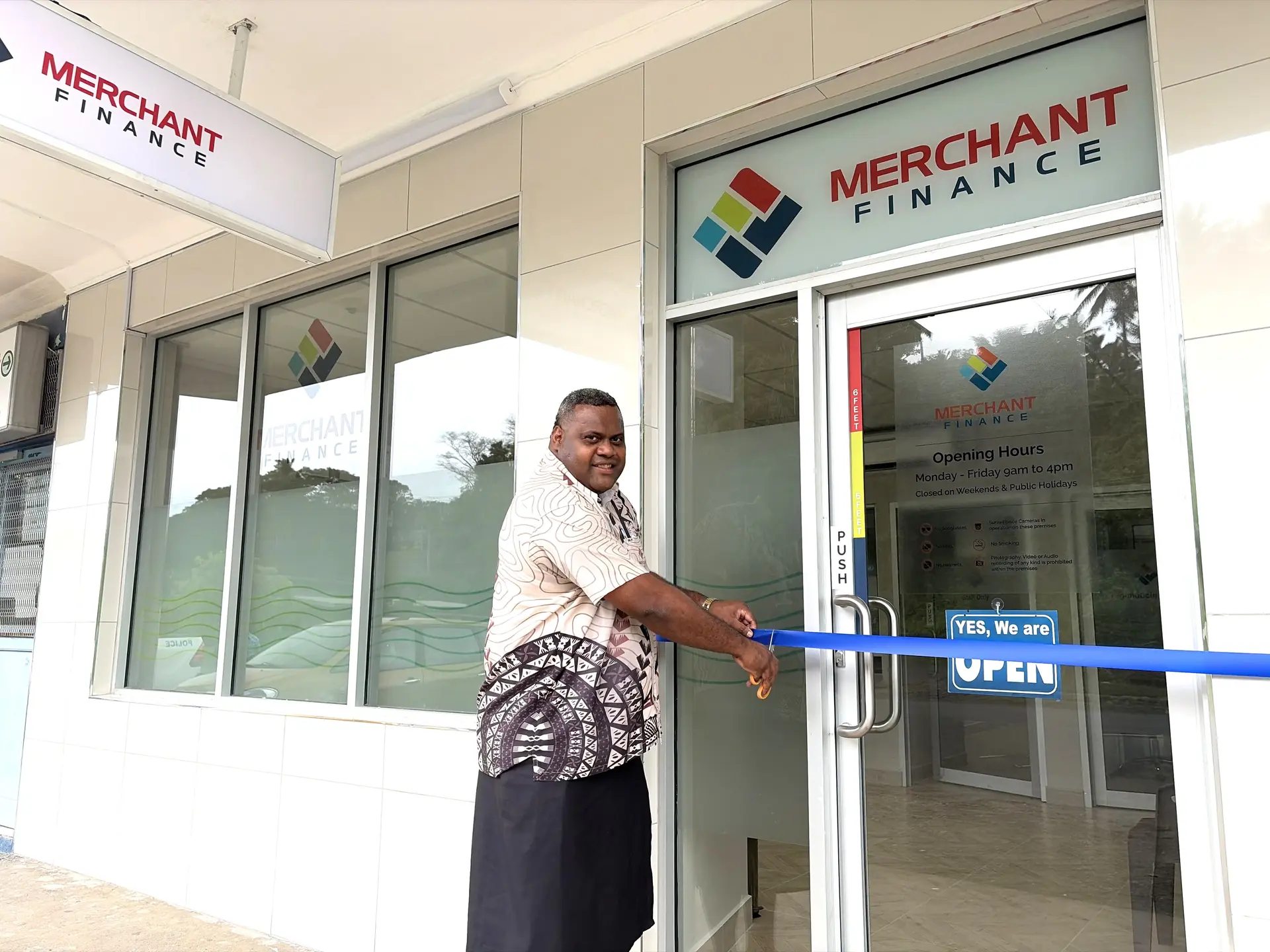 Merchant Finance Chief Operating Officer Aminiasi Katuba cuts the ribbon at the opening of Merchant Finance's new branch in Waiyevo, Taveuni.