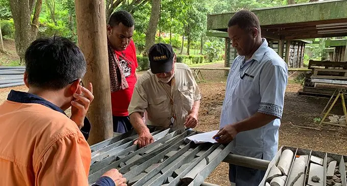 Lion One Metals chief executive officer, Walter Berukoff (wearing a hat), at Tuvatu alkaline gold core shed, Sabeto.