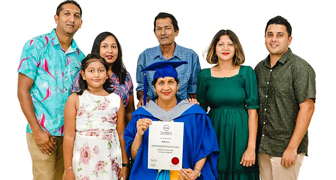 Bimla Sharma in her graduation gown with her family after receiving her Bachelor certificate from Fiji National University in Suva on January 5, 2021.