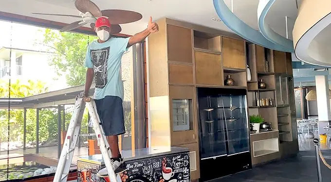 A staff member of Sofitel Fiji Resort and Spa working on the final touches around the restaurant area.