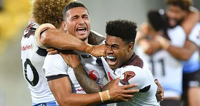 Marcelo Montoya (middle) is hugged by Eloni Vunakece and Kevin Naiqama after the Vodafone Fijian Bati scored an upset 4-2 win over New Zealand at the 2017 World Cup in Eden Park, Auckland.