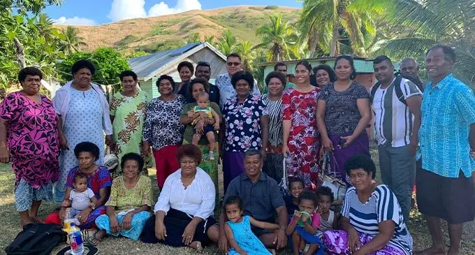 JR Group Director Jason Raj (standing (back-row middle) wearing sunglass) with his team and the villagers.