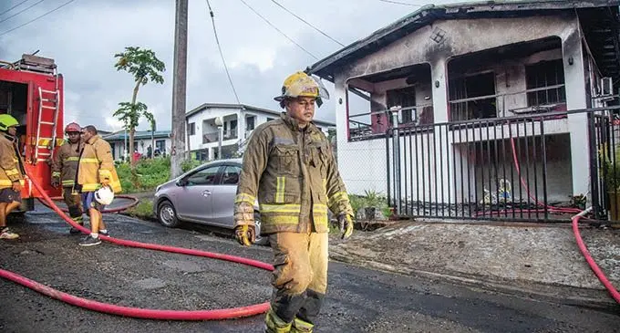 National Fire Authority firemen with the remains of a house that caught fire on Filipi Street, off Niudamu Road, Tacirua Heights on June 24, 2021. Photo: Leon Lord