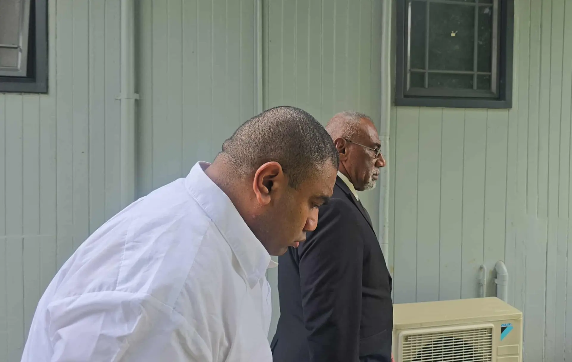 Accused Eroni Kitanamati (closest to camera) with his lawyer Joji Cakau outside the Suva Courthouse on October 20, 2025.