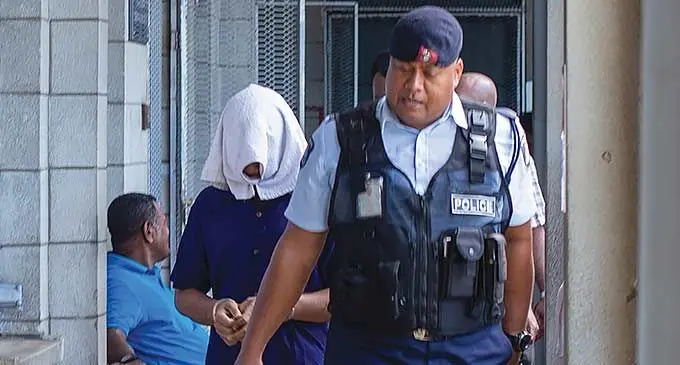 An accused on his way to court. Photo: Leon Lord
