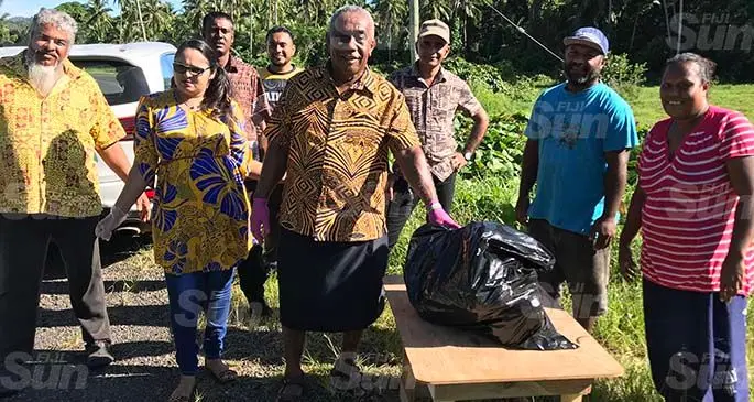 Assistant Minister for Rural and Maritime Development and DisasterManagement Jale Sigarara (front row, third from left) is accompanied by members of the Seaqaqa business community to give food packages to Emi Diabe (far right) and Josateki Lala (second from right)on April 24, 2020. Photo: Shratika Naidu