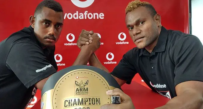 From left Nemani Vanua and Sikeli Vunidogo in front of the Arm Wrestling Championship belt at the Vodafone headquarters yesterday.