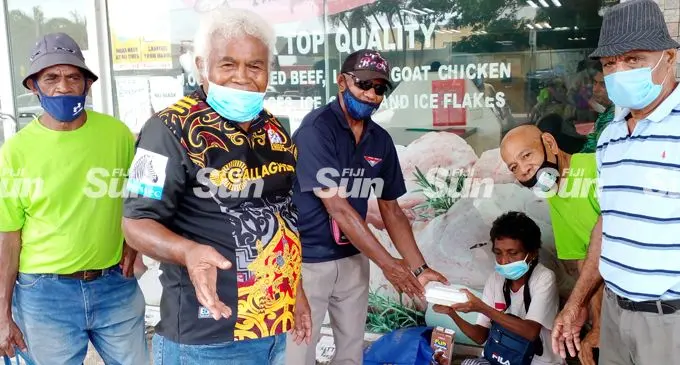 Vunivaivai Senior Citizens of Lautoka members, from left: Ilaisa Leca, spokesperson Eparama Roko,Jone Vonu, Fereti Nawai and Sakaia Momoivawa give a food pack to Nirmala Devi on February 11,2022. Photo: Salote Qalubau
