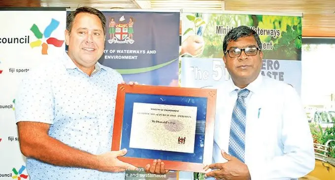 Minister for Environment Waterways and Agriculture, Mahendra Reddy, hands over the certificate to Marc McElrath during global recycling day in Suva, on March 18, 2021. Photo: Ronald Kumar