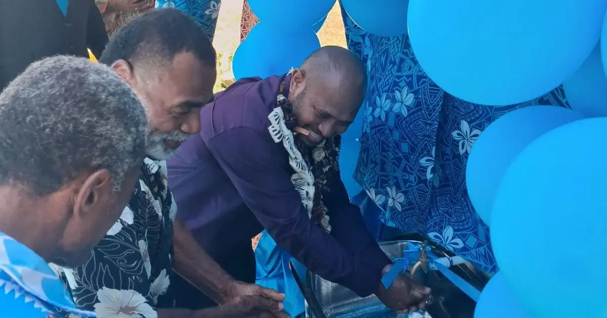 Divisional health inspector North, Vakaruru Cavuilati (garland) showing invited guests how to wash hands at Kubulau District School in Bua 