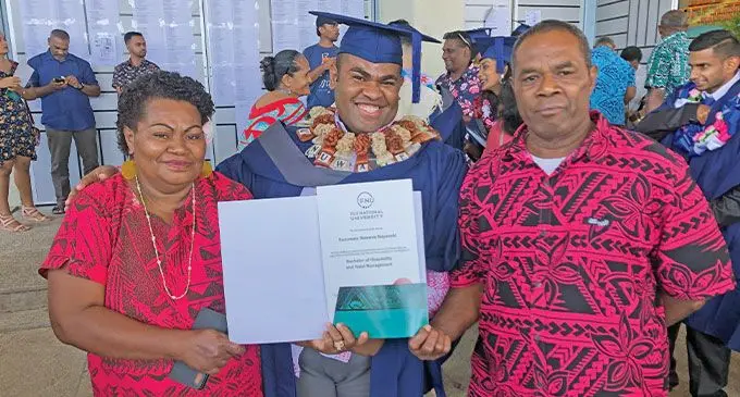 Sunuwale Nayavaki with his parents Ruci (left) and Kaminieli Waibote (right) during his Fiji National University (FNU) graduation on Thursday, September 29, 2022. Photo: Josefa Babitu