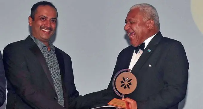 Fiji Airports acting chief executive officer Faiz Khan receives the Excellence in Business Leadership Award from Prime Minister Voreqe Bainimarama at the Sheraton Fiji Resort on November 16, 2019. Photo: Waisea Nasokia.