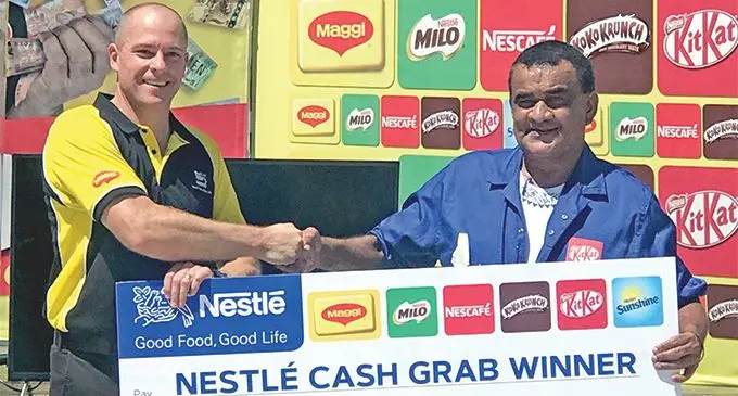 Nestle Fiji general manager Jason Jezewski with one of the Nestle Cash Grab Promotion winners, Pita Lagi. Photo: Kelera Sovasiga