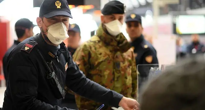 A policeman with a face mask is on duty at Milan Central Railway Station in Milan, Italy, on March 9, 2020. (Photo by Daniele Mascolo/Xinhua) 