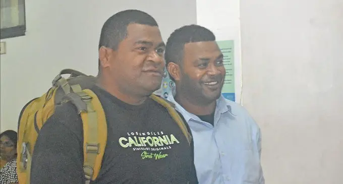 Police Constable Iosefo Vakasukaonotabua (left), escorts Kaliova Nalibu out of the Magistrates Court in Nadi on September 21, 2022. Photo: Salote Qalubau