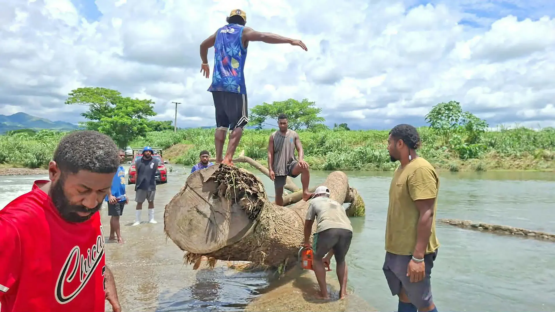 Youths of Toge clear debris and pile rocks to repair the damaged road. 