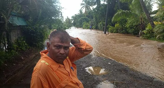 Sundressan waits for the water level to recede on the Tore Seaside Road.   