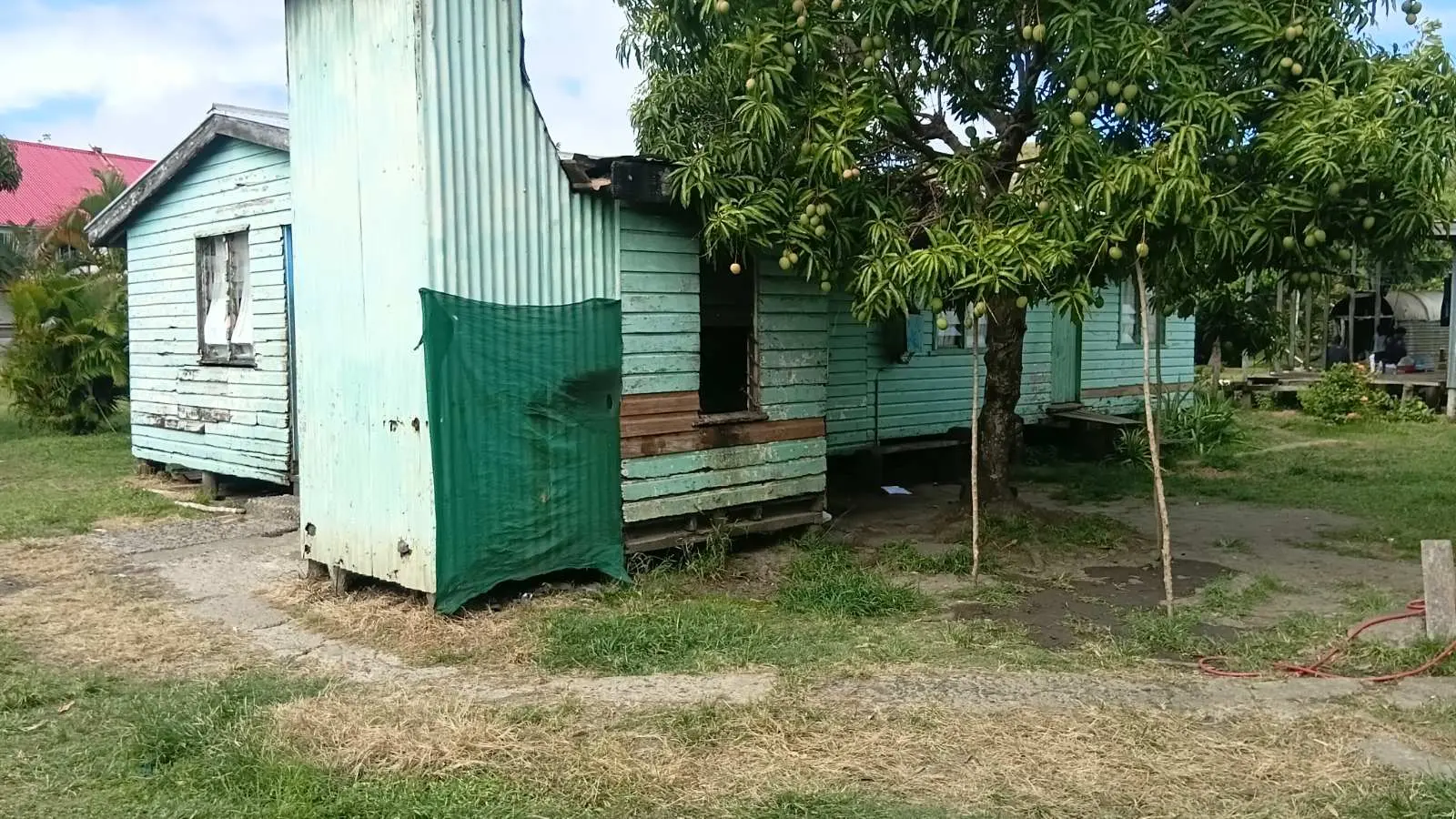 The green material on the building was damaged by large waves from the sea. 