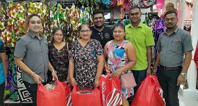 Suva Meenoo’s branch manager Avinesh Krishna (right) with staff and customers