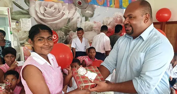 Vodafone Fiji sponsorship manager Adriu Vakarau (right), presenting a gift to a Gospel School for the Deaf student during the International Day of Education celebration in Suva on January 25, 2021.