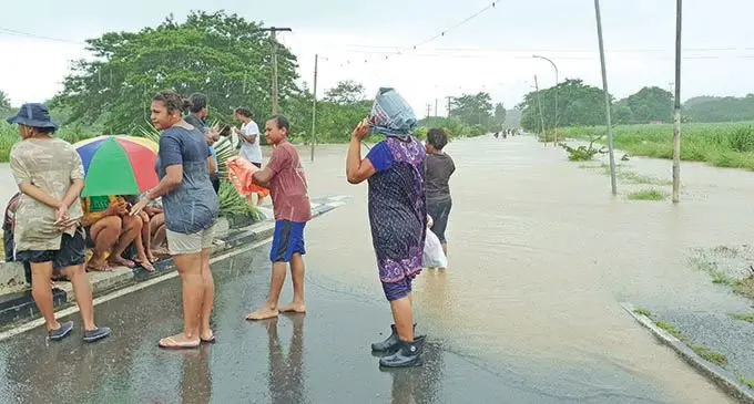 STRANDED... People seek dry land after wading through the flooded road that leads into Ba Town on January 29, 2021.  Photo: Nicolette Chambers