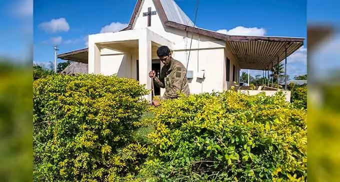 New Zealand personnel helping clean the church compound at Nausori Village.