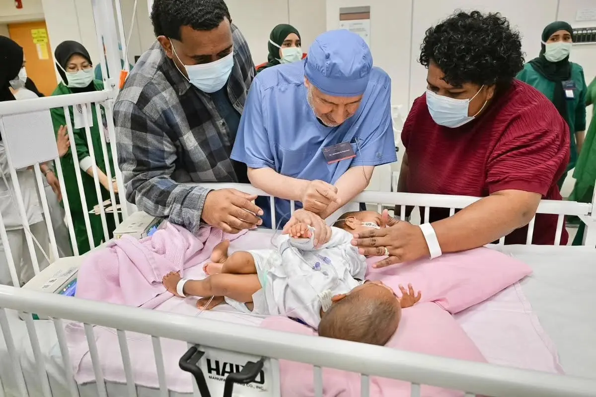 Dr. Abdullah Al-Rabeeah inspecting conjoined twins Jasepeli and Desicia ahead of the operation.